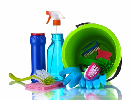 Cleaner in W14 sanitising an office workspace