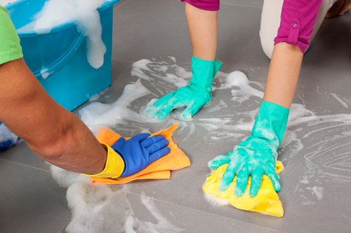 Professional oven cleaner in W14 removing grease from a kitchen oven
