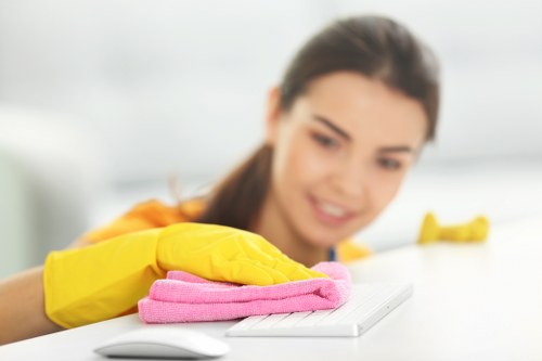 A cleaner preparing windows in W14 using professional equipment