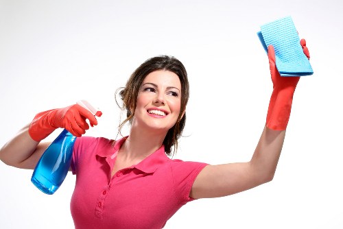 Trained carpet cleaner using protective gloves and footwear during work